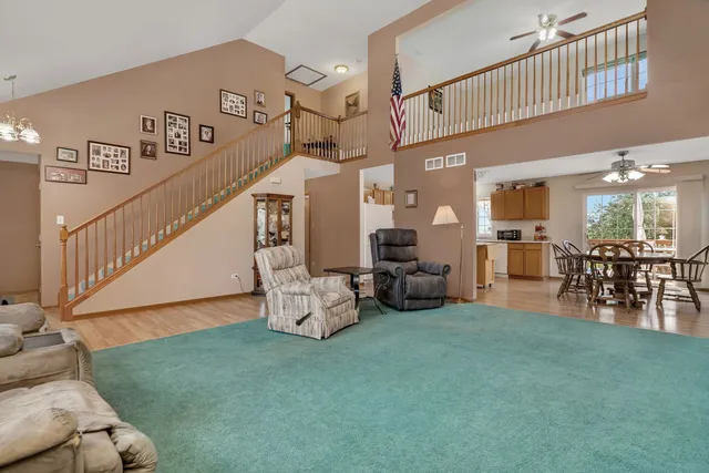 a view of a livingroom with furniture and a floor to ceiling window