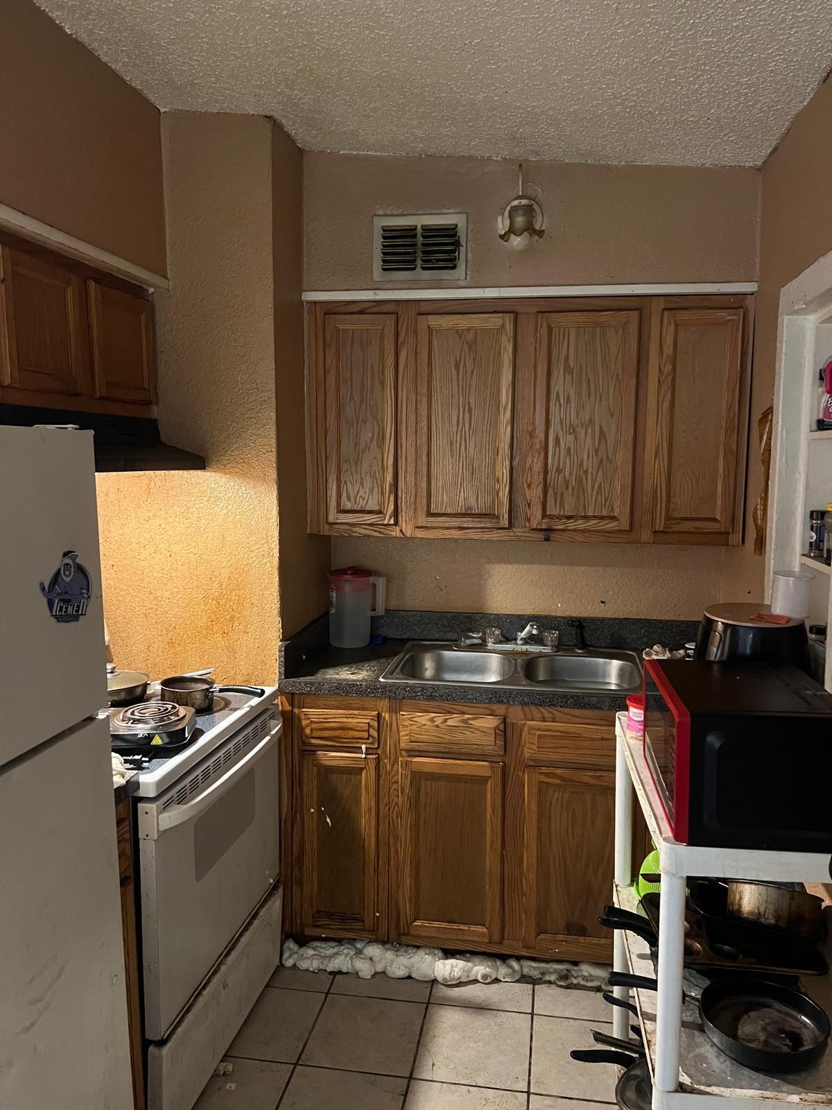 a kitchen with a stove and a refrigerator