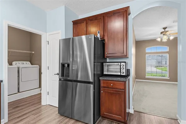a view of kitchen with sink and refrigerator