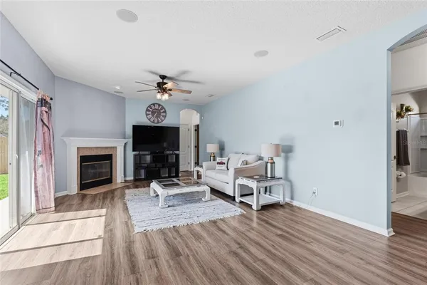 a living room with furniture a fireplace and a chandelier