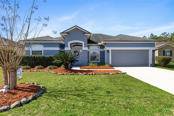 a front view of a house with a yard