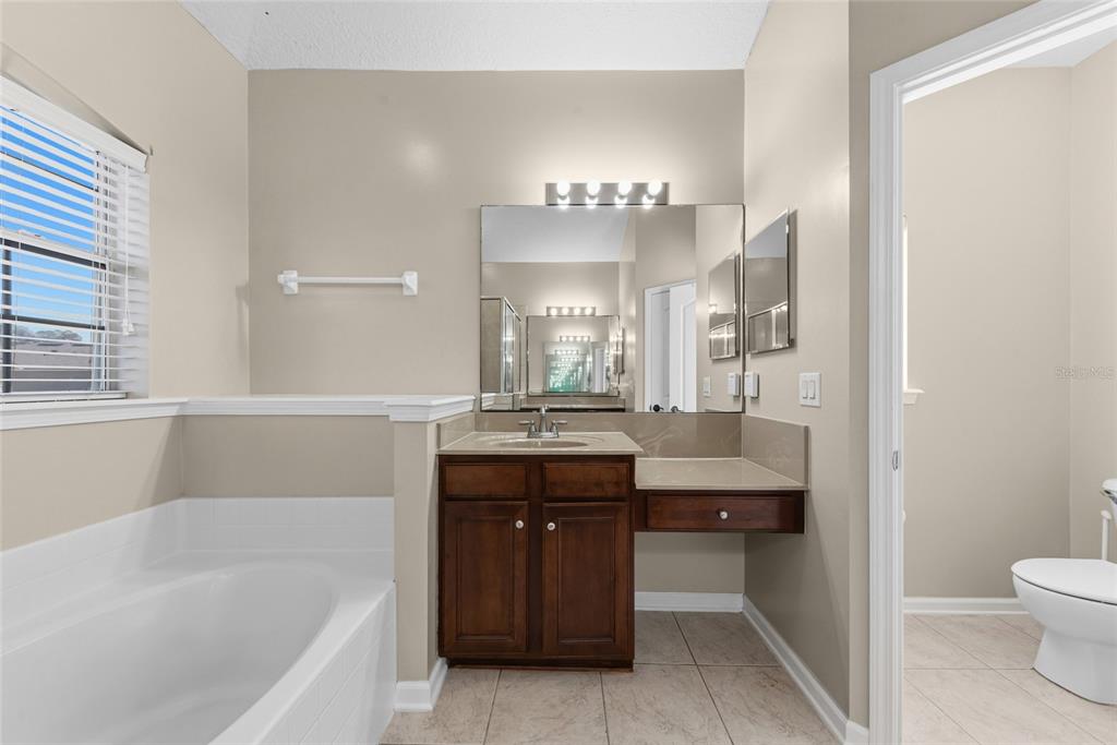 45095 Dutton Way Callahan, FL 32011 - Photo 27 of 36 a bathroom with a tub sink and mirror