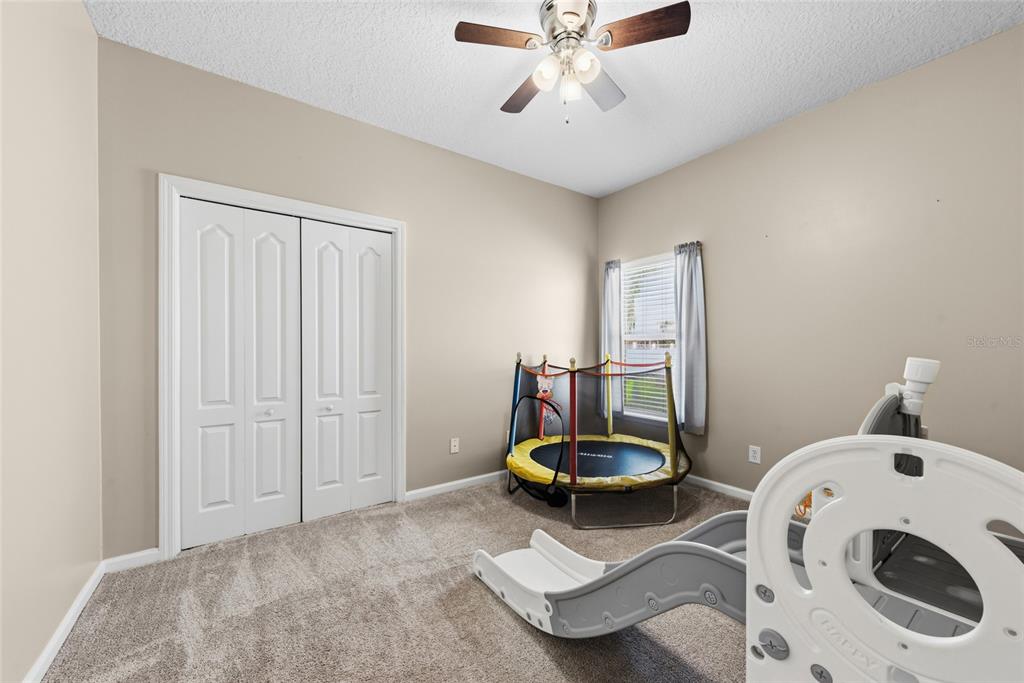 45095 Dutton Way Callahan, FL 32011 - Photo 28 of 36 a living room with a bed and furniture