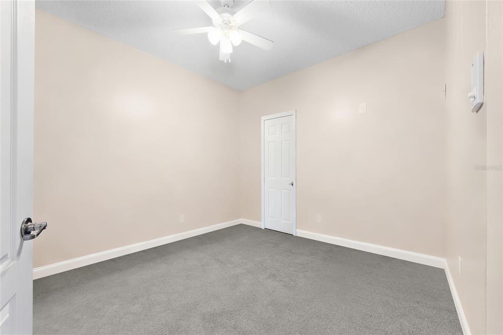 45095 Dutton Way Callahan, FL 32011 - Photo 30 of 36 an empty room with a fan & a window