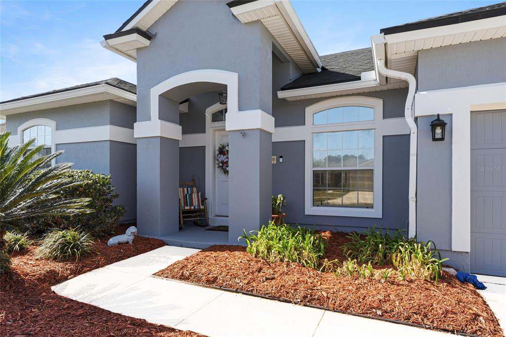 45095 Dutton Way Callahan, FL 32011 - Photo 3 of 36 a front view of a house with garden