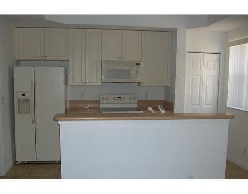 2928 Hidden Hills Road, Unit 1403 West Palm Beach, FL 33411 - Photo 2 of 13 a view of kitchen with cabinets