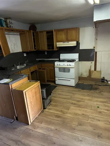 a kitchen with granite countertop a stove and a microwave