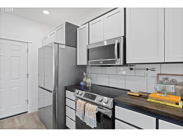 a kitchen with a refrigerator and a sink