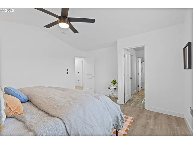 a bedroom with a bed and a ceiling fan