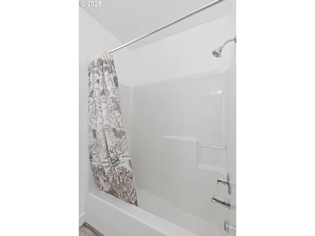 a bathroom with a bathtub and shower