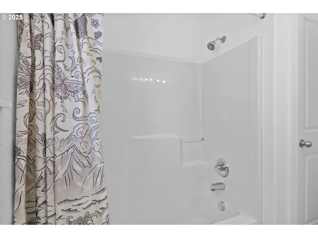 a bathroom with a shower curtain and a shower curtain