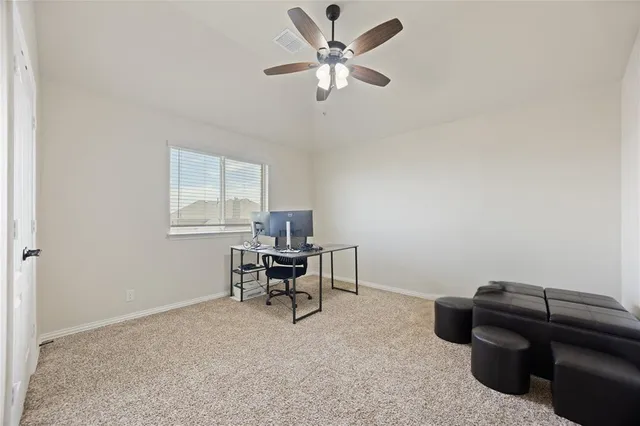 a work room with furniture and a window