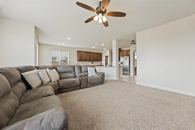 a living room with furniture and kitchen view