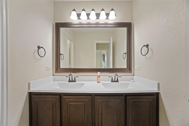 a bathroom with a sink vanity and a mirror