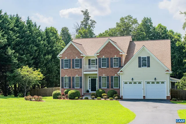 a view of a house with garden and trees