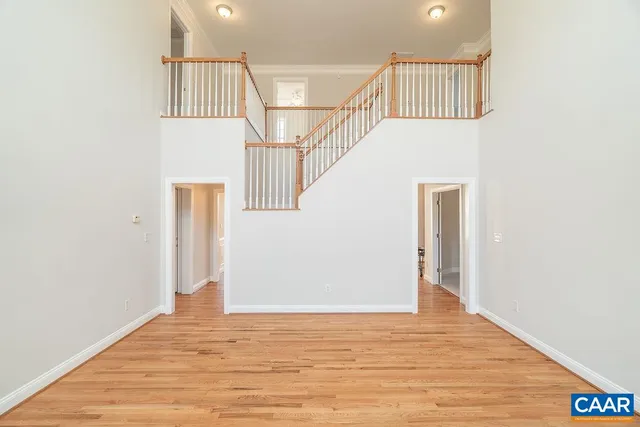 a kitchen with stainless steel appliances a dining table chairs stove refrigerator and cabinets