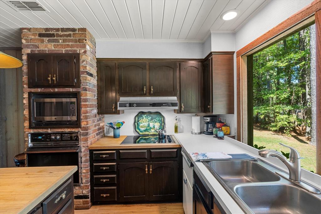 1200 North Acres Circle Springhill, LA 71075 - Photo 21 of 40 a kitchen with a sink stove and microwave
