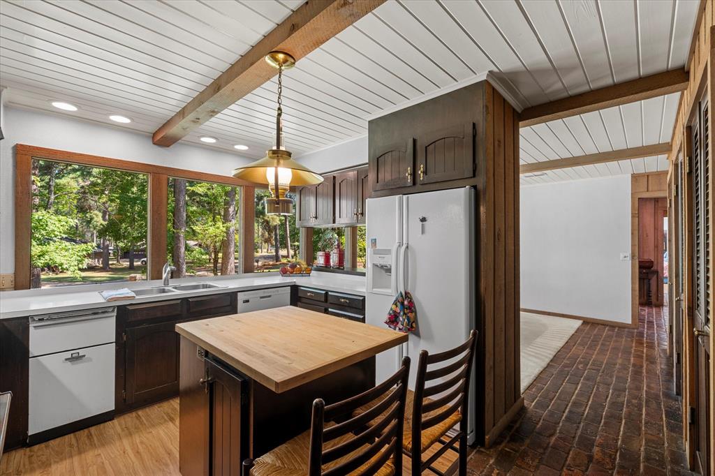 1200 North Acres Circle Springhill, LA 71075 - Photo 22 of 40 a kitchen with stainless steel appliances granite countertop a refrigerator a sink dishwasher a stove and white countertops with wooden floor