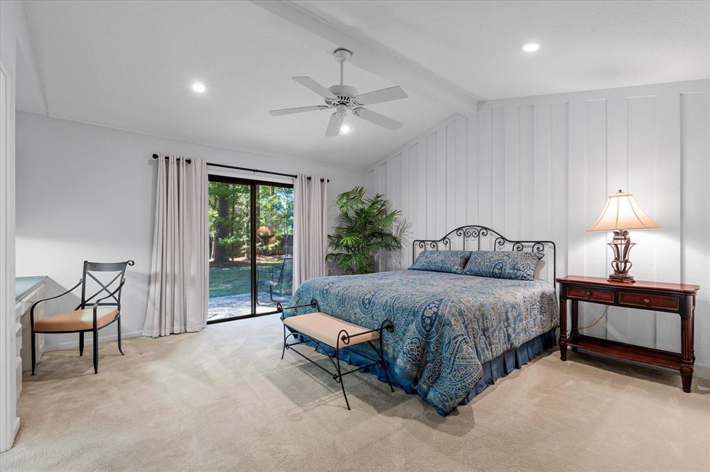 1200 North Acres Circle Springhill, LA 71075 - Photo 24 of 40 a spacious bedroom with a bed and a chandelier