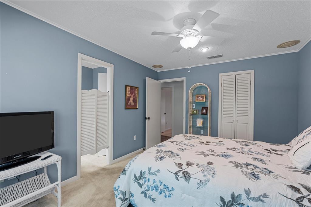 1200 North Acres Circle Springhill, LA 71075 - Photo 32 of 40 a bedroom with a bed and a flat screen tv