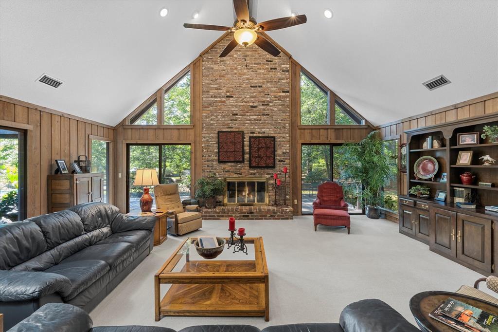1200 North Acres Circle Springhill, LA 71075 - Photo 7 of 40 a living room with furniture a flat screen tv and a floor to ceiling window