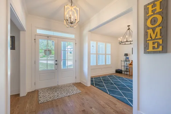 a view of an entryway with wooden floor