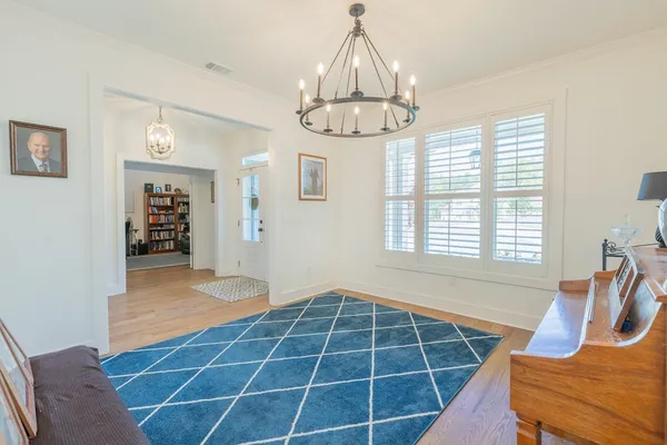 a view of a room with windows and wooden floor