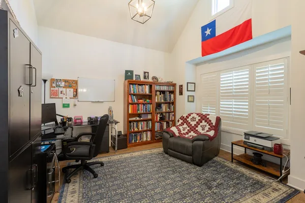 a living room with furniture and a book shelf