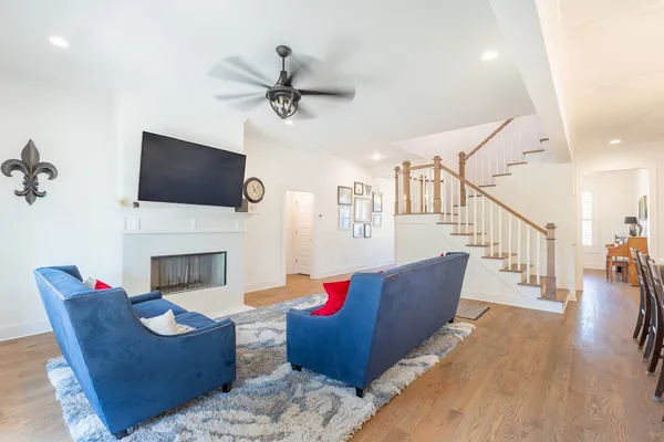 a living room with furniture a fireplace and a flat screen tv