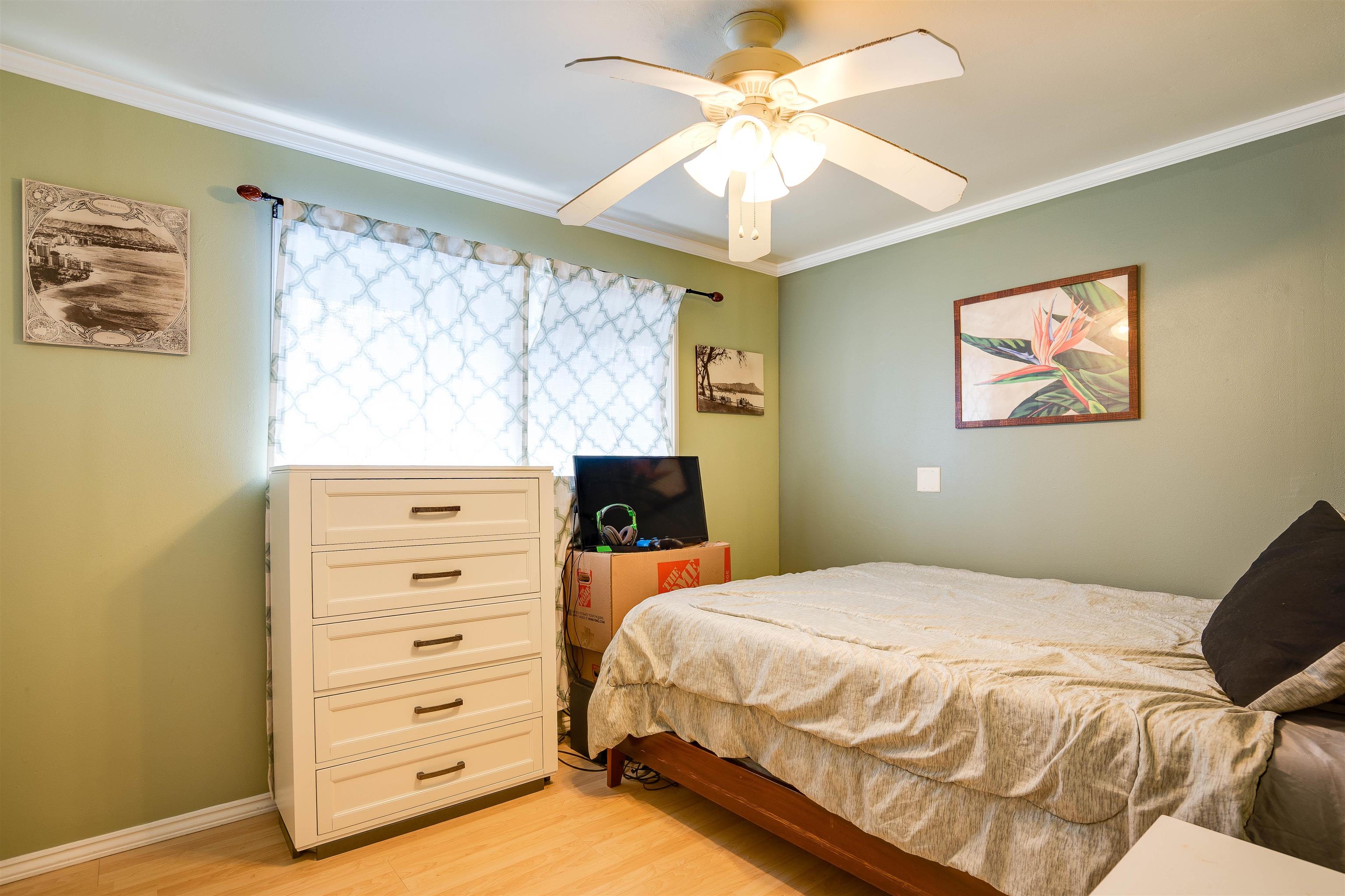 8 Laupapa Place Haiku, HI 96708 - Photo 12 of 30 a bedroom with a bed and a chandelier