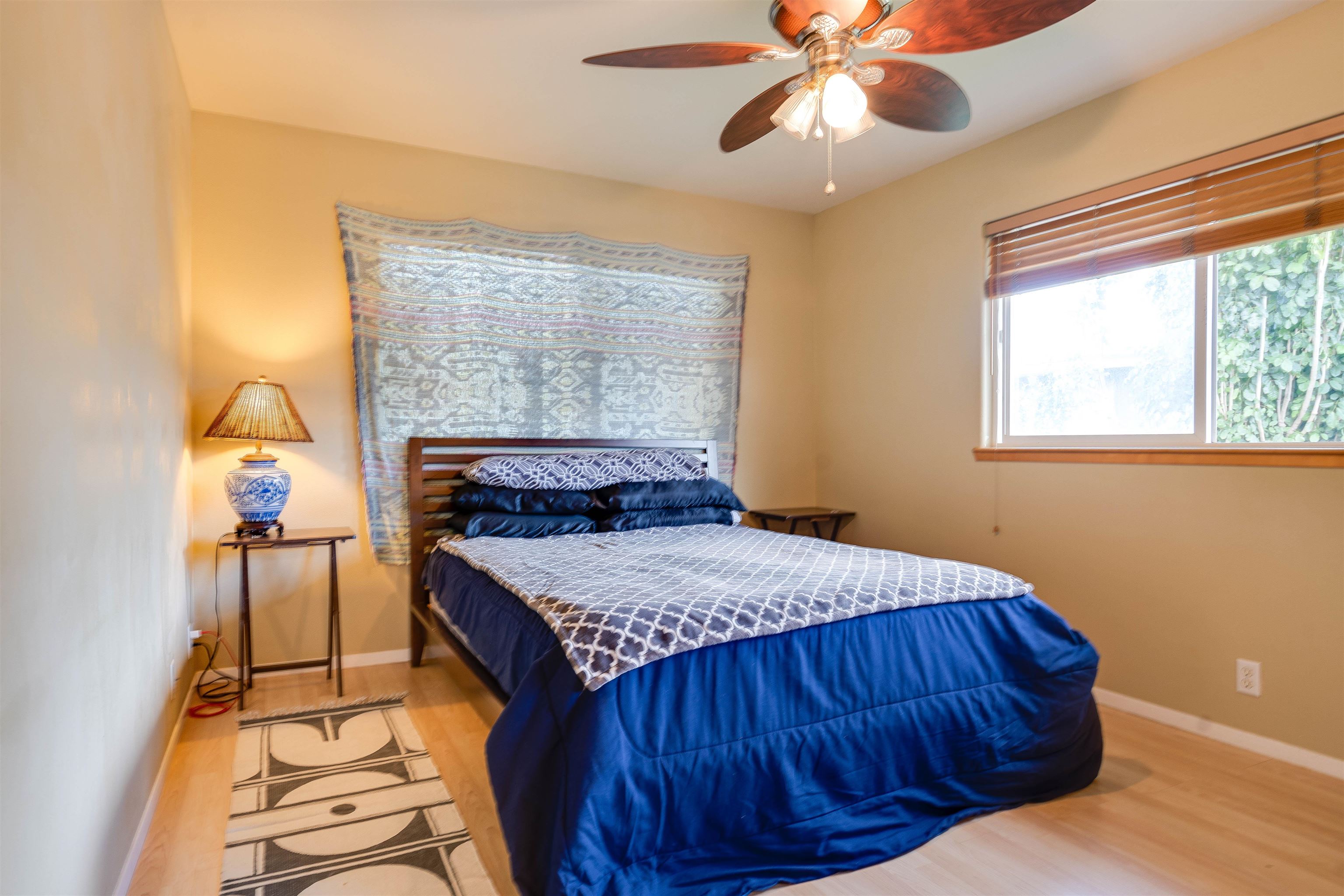 8 Laupapa Place Haiku, HI 96708 - Photo 23 of 30 a bedroom with a bed and a chandelier