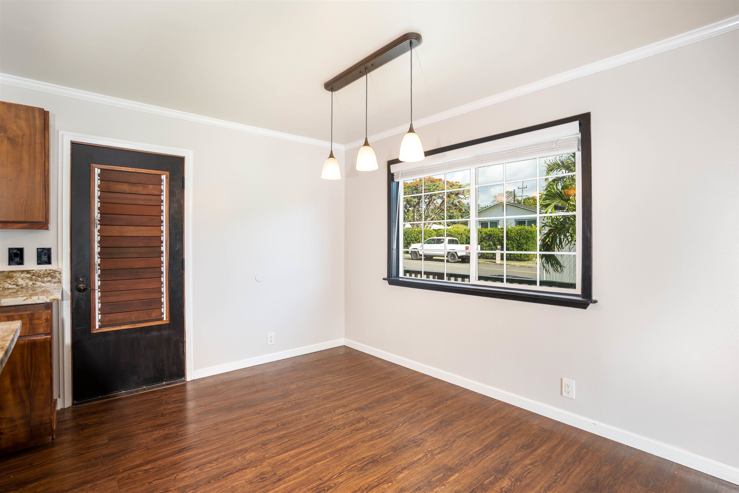 8 Laupapa Place Haiku, HI 96708 - Photo 6 of 30 an empty room with wooden floor cabinet and windows