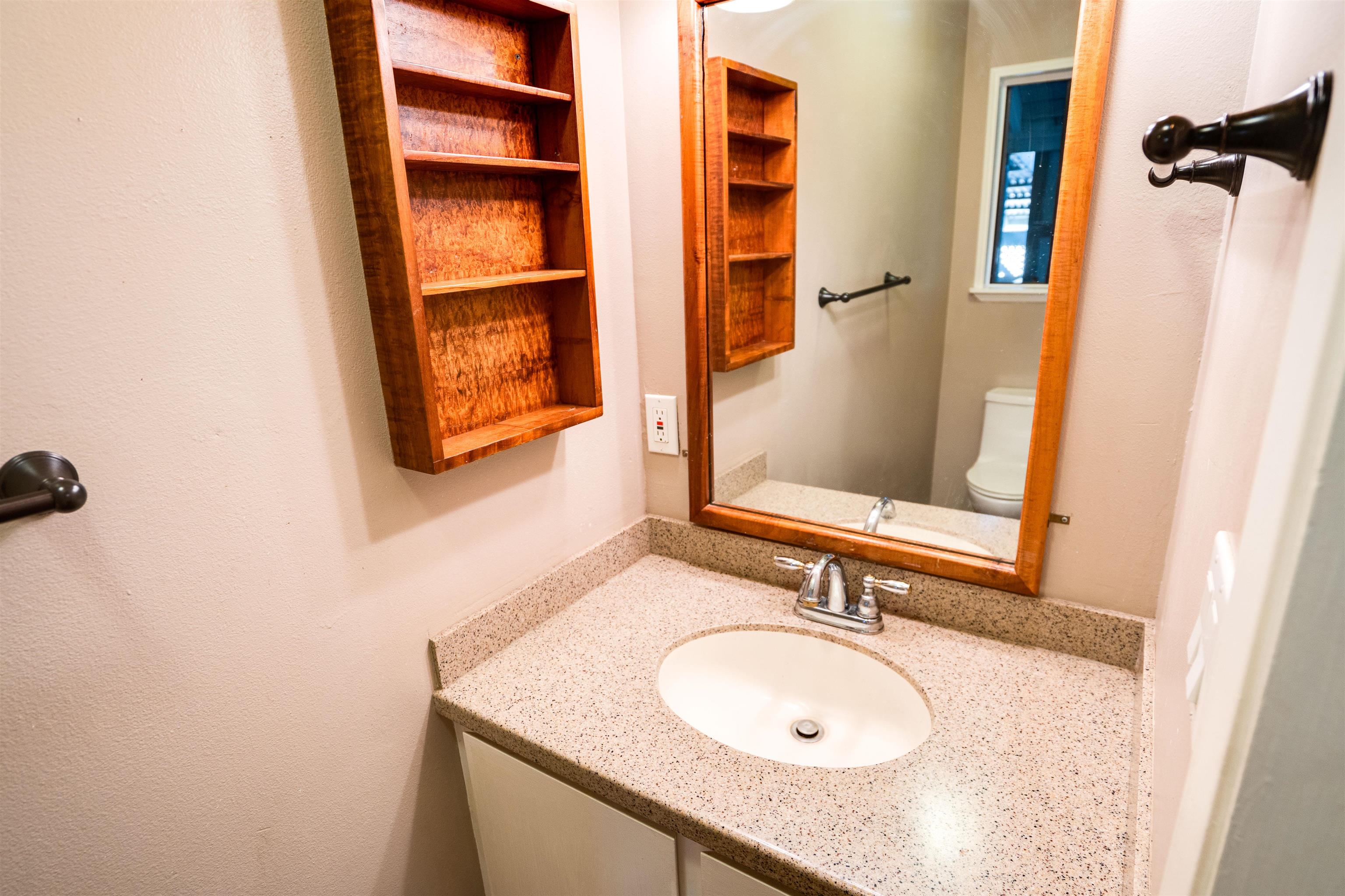 8 Laupapa Place Haiku, HI 96708 - Photo 9 of 30 a bathroom with a sink and a mirror