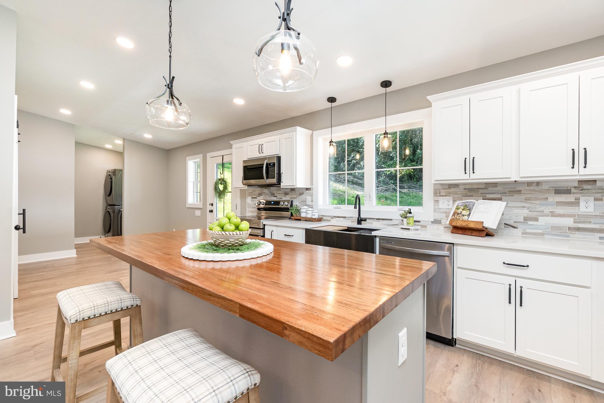 1803 Susquehanna Hall Road Whiteford, MD 21160 - Photo 13 of 49 a large kitchen with kitchen island a large island in it