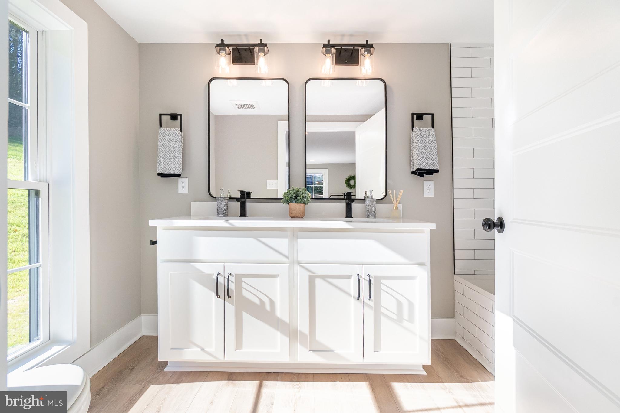 1803 Susquehanna Hall Road Whiteford, MD 21160 - Photo 23 of 49 a bathroom with a double vanity sink mirror and