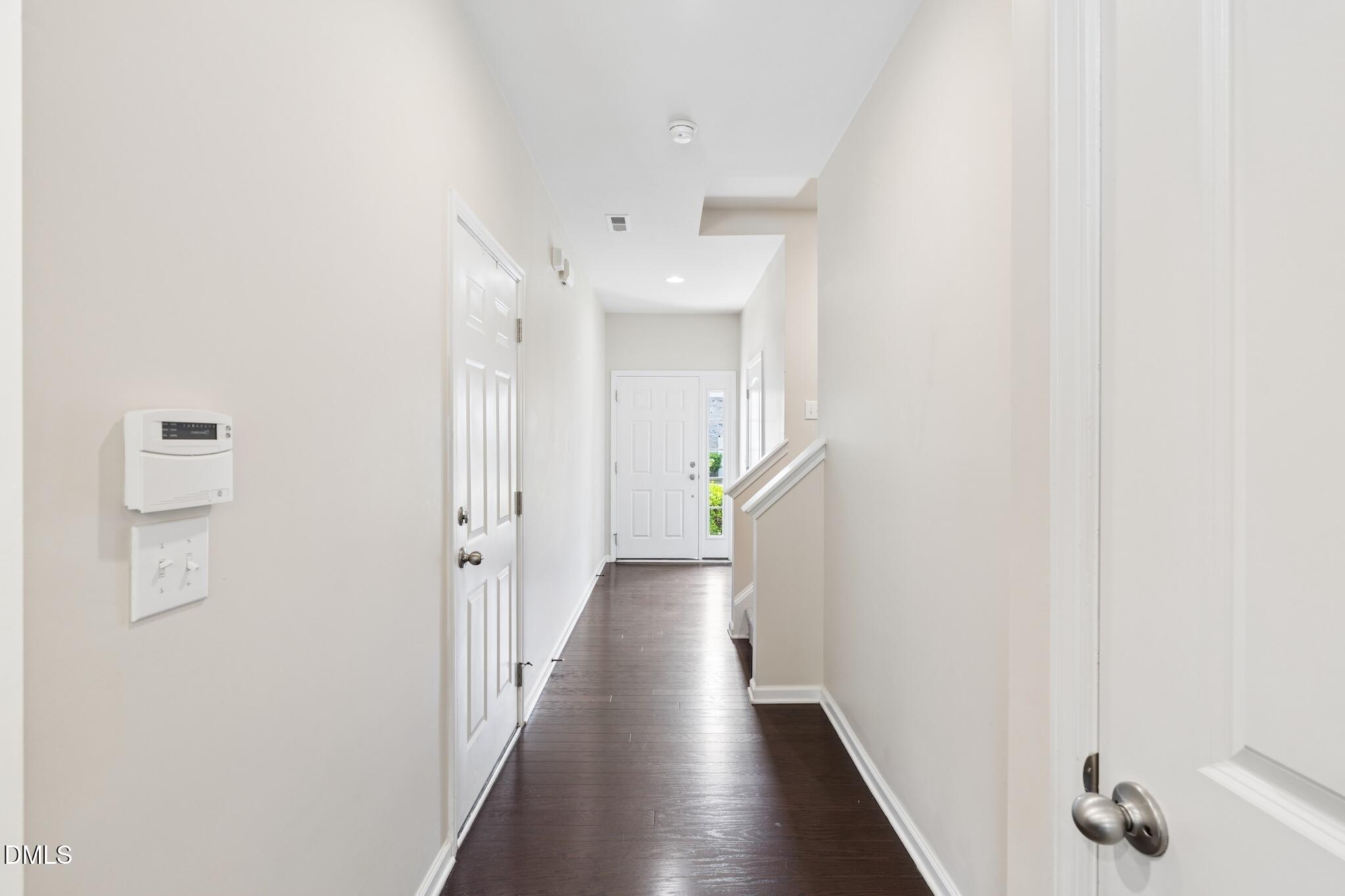 110 Marsena Lane Cary, NC 27513 - Photo 10 of 46 a view of a hallway with wooden floor