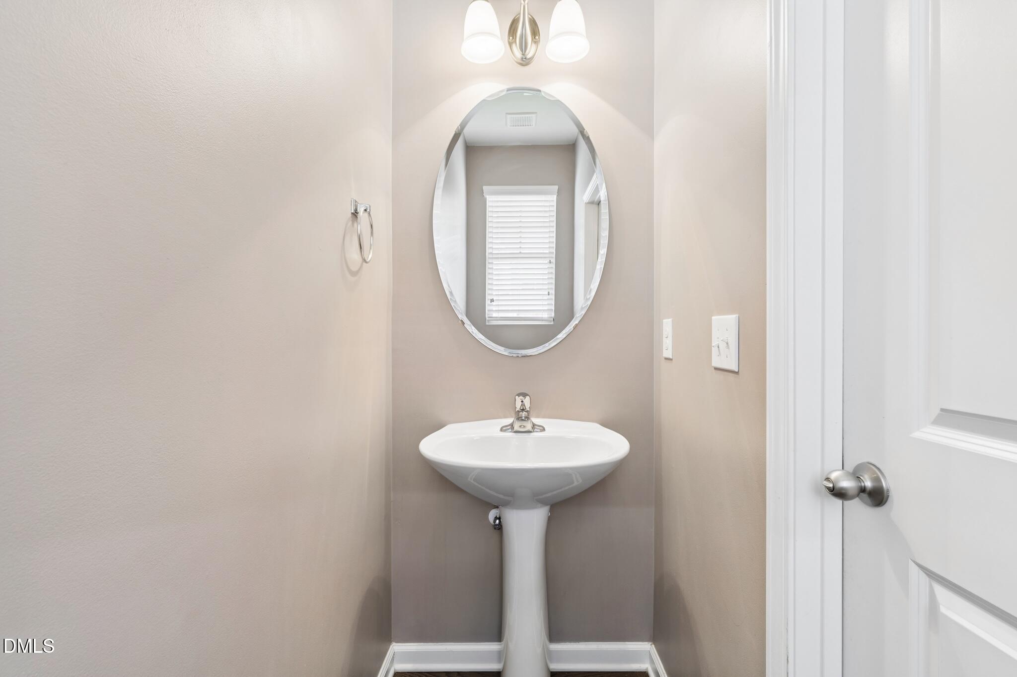 110 Marsena Lane Cary, NC 27513 - Photo 11 of 46 a bathroom with a sink and a mirror