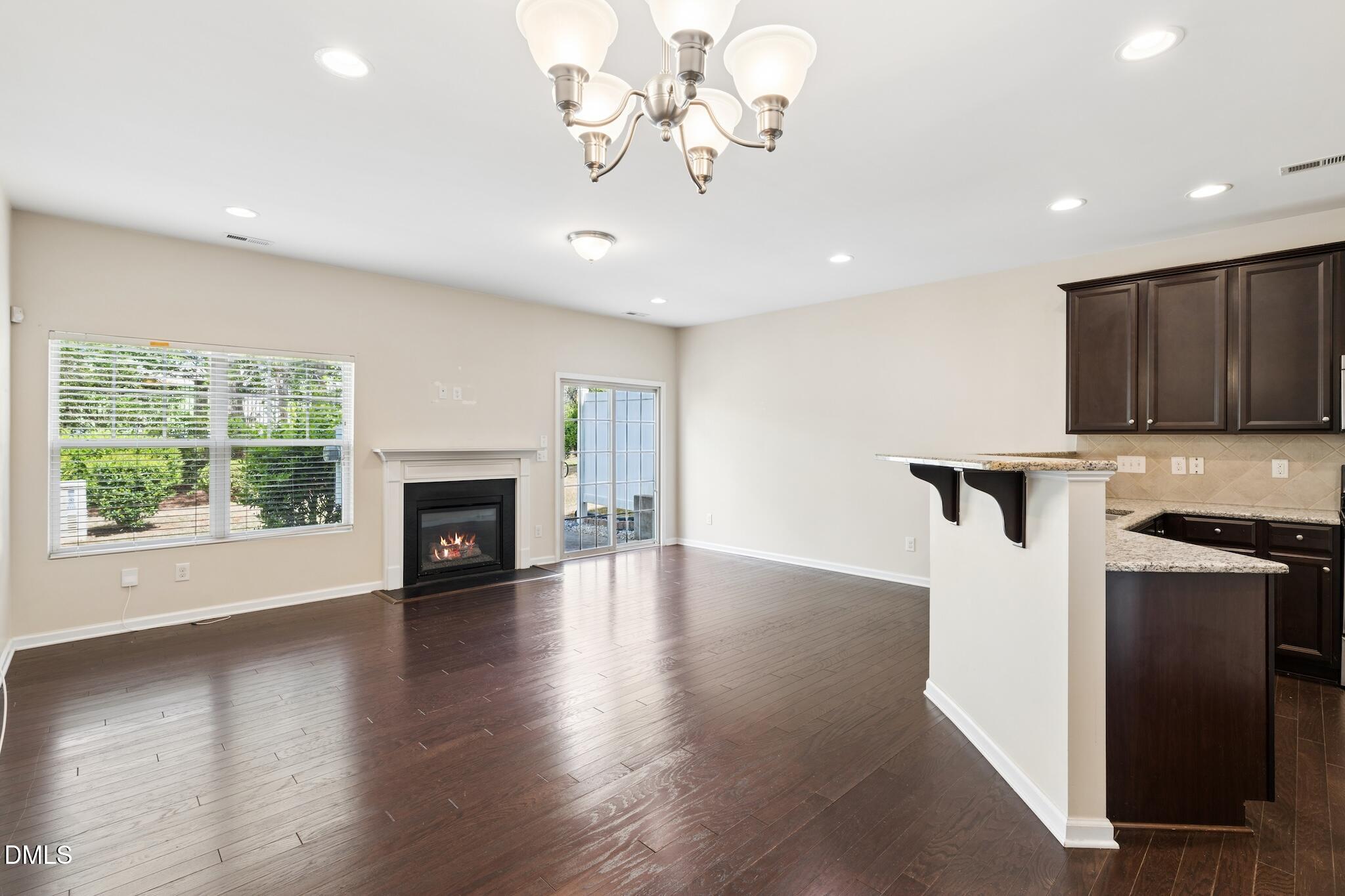 110 Marsena Lane Cary, NC 27513 - Photo 15 of 46 a view of an empty room with window and wooden floor