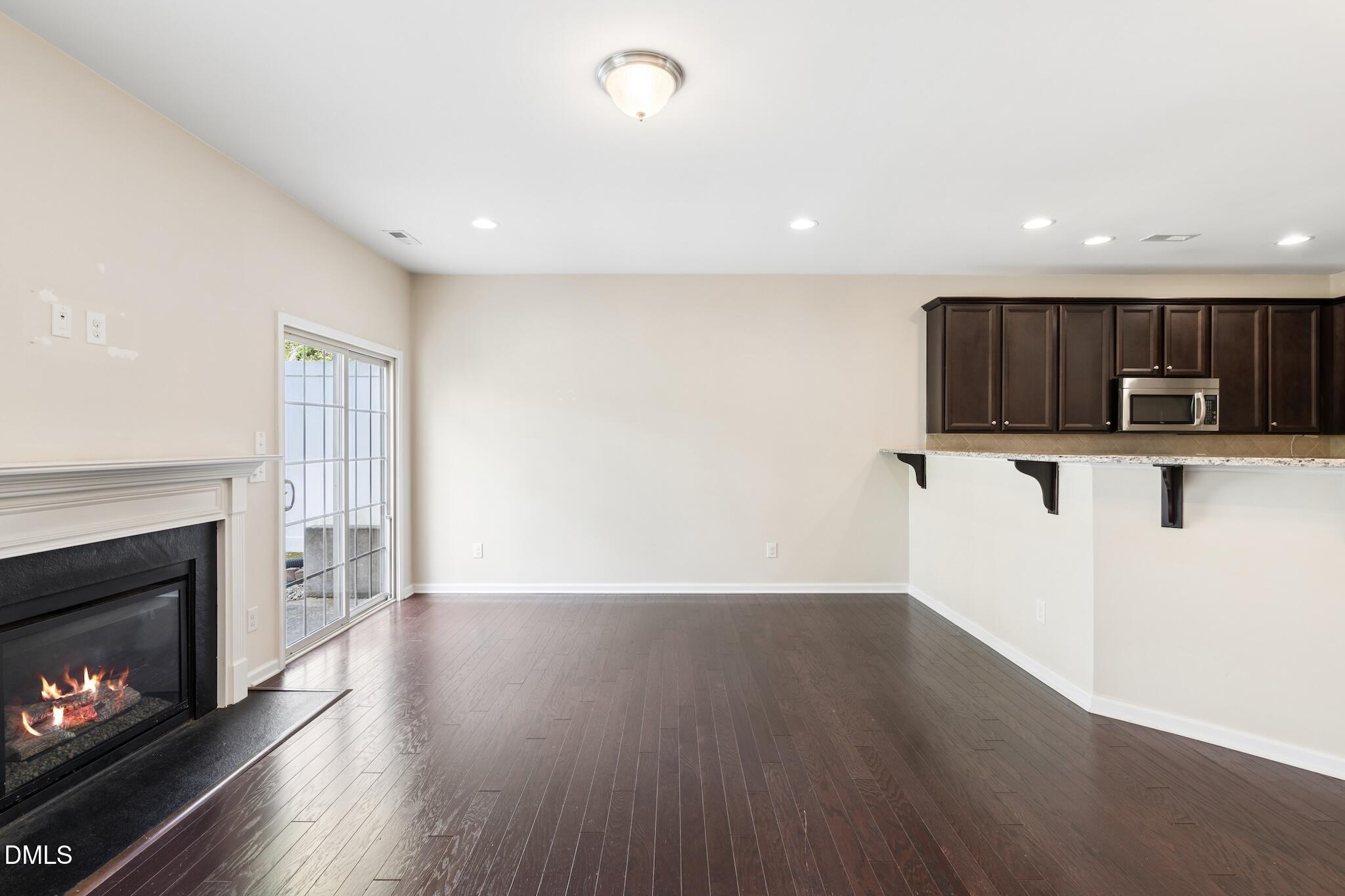 110 Marsena Lane Cary, NC 27513 - Photo 16 of 46 a view of a kitchen with wooden floor and a fireplace
