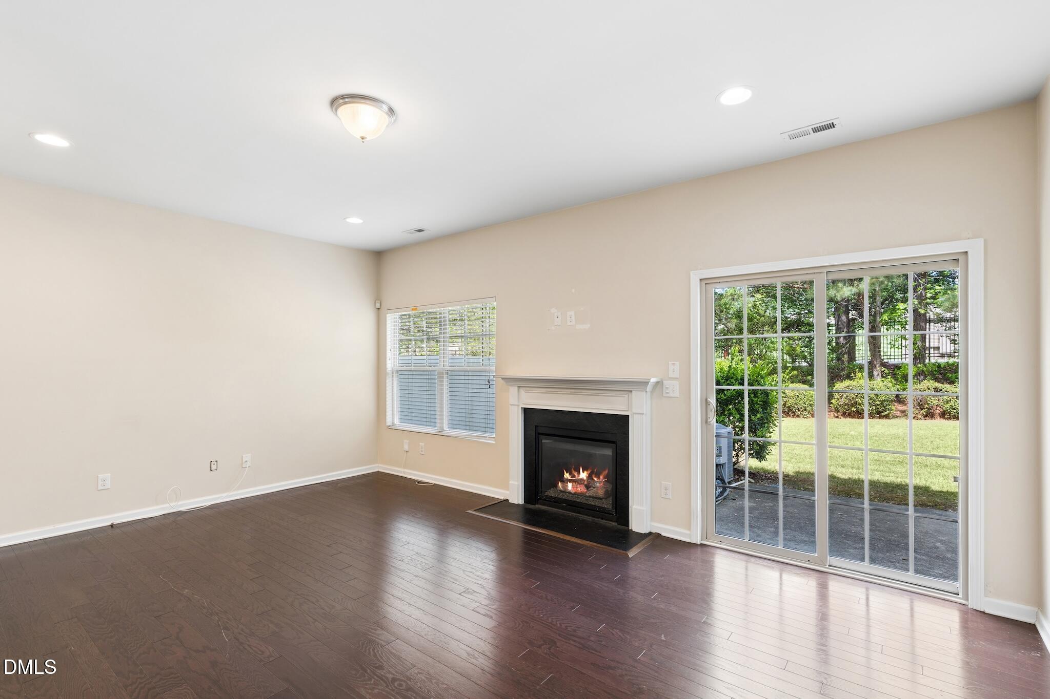 110 Marsena Lane Cary, NC 27513 - Photo 20 of 46 a view of empty room with wooden floor and fireplace