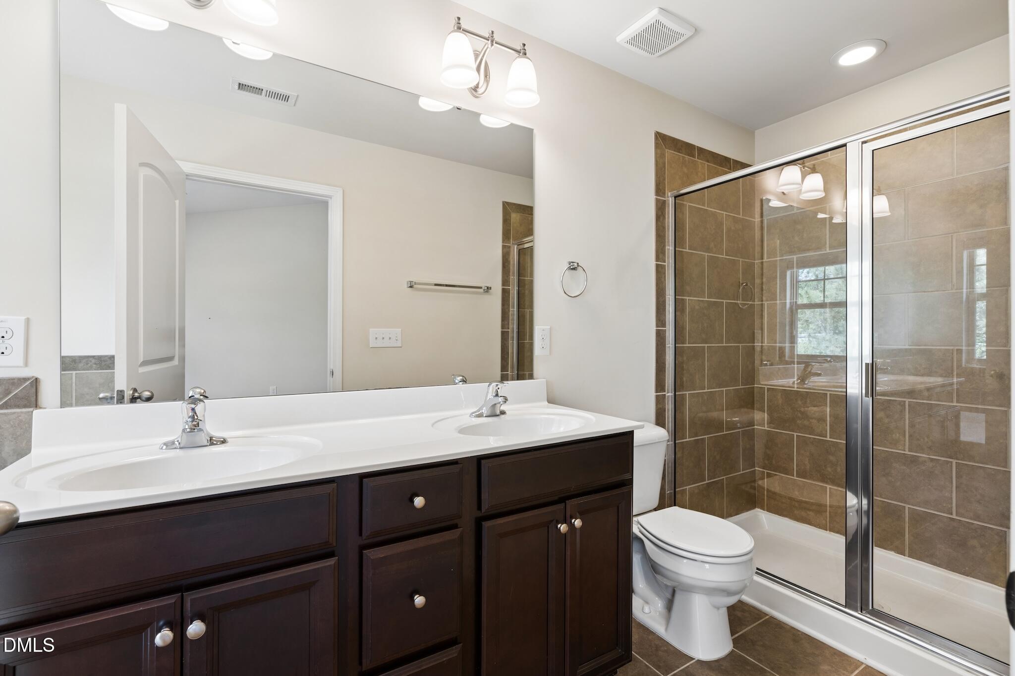 110 Marsena Lane Cary, NC 27513 - Photo 29 of 46 a bathroom with a sink shower and a toilet