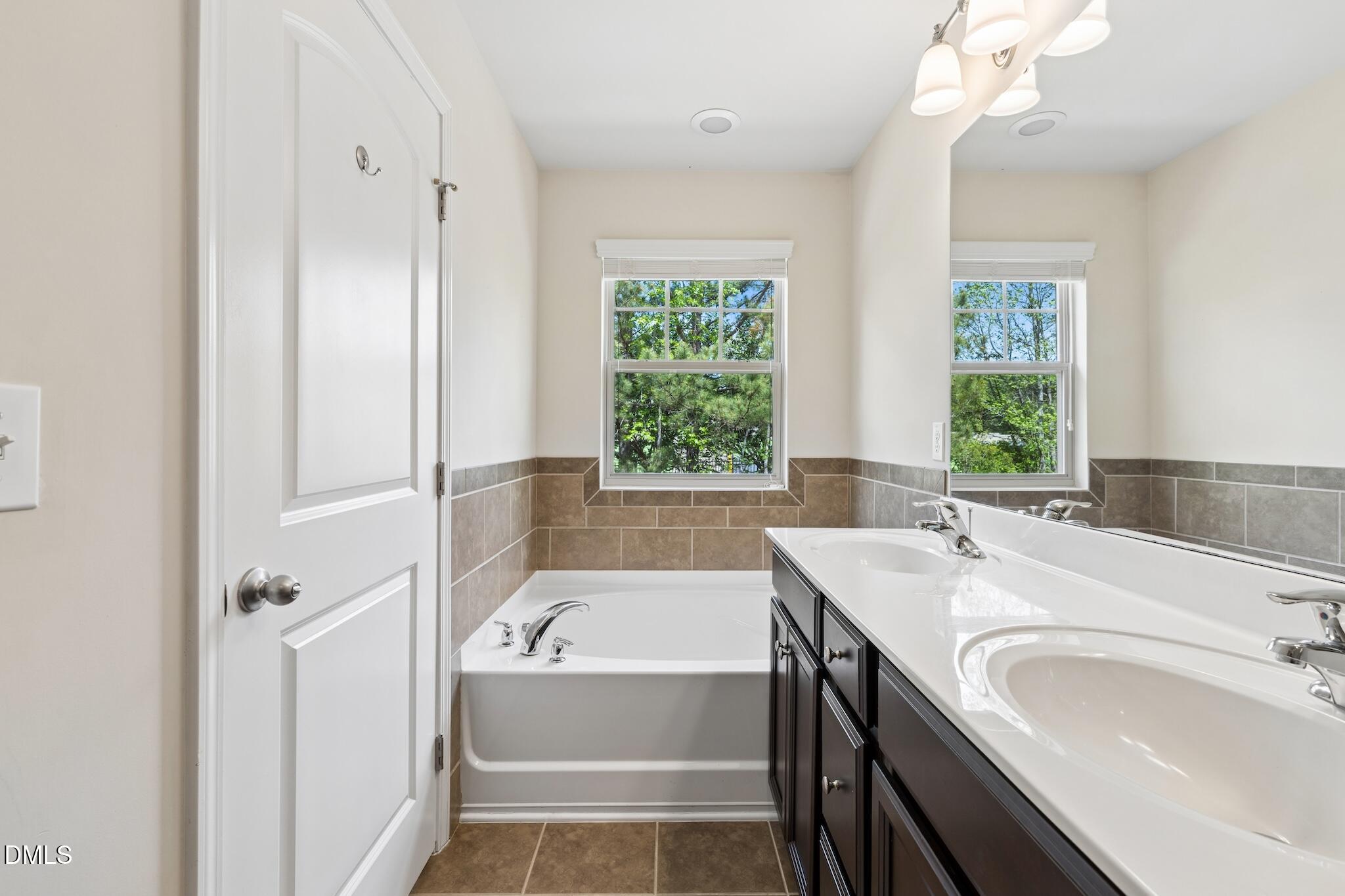 110 Marsena Lane Cary, NC 27513 - Photo 31 of 46 a bathroom with a tub sink and mirror