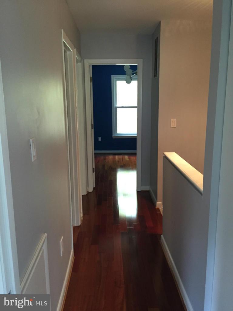 9042 Saffron Lane Silver Spring, MD 20901 - Photo 21 of 21 a view of hallway with wooden floor