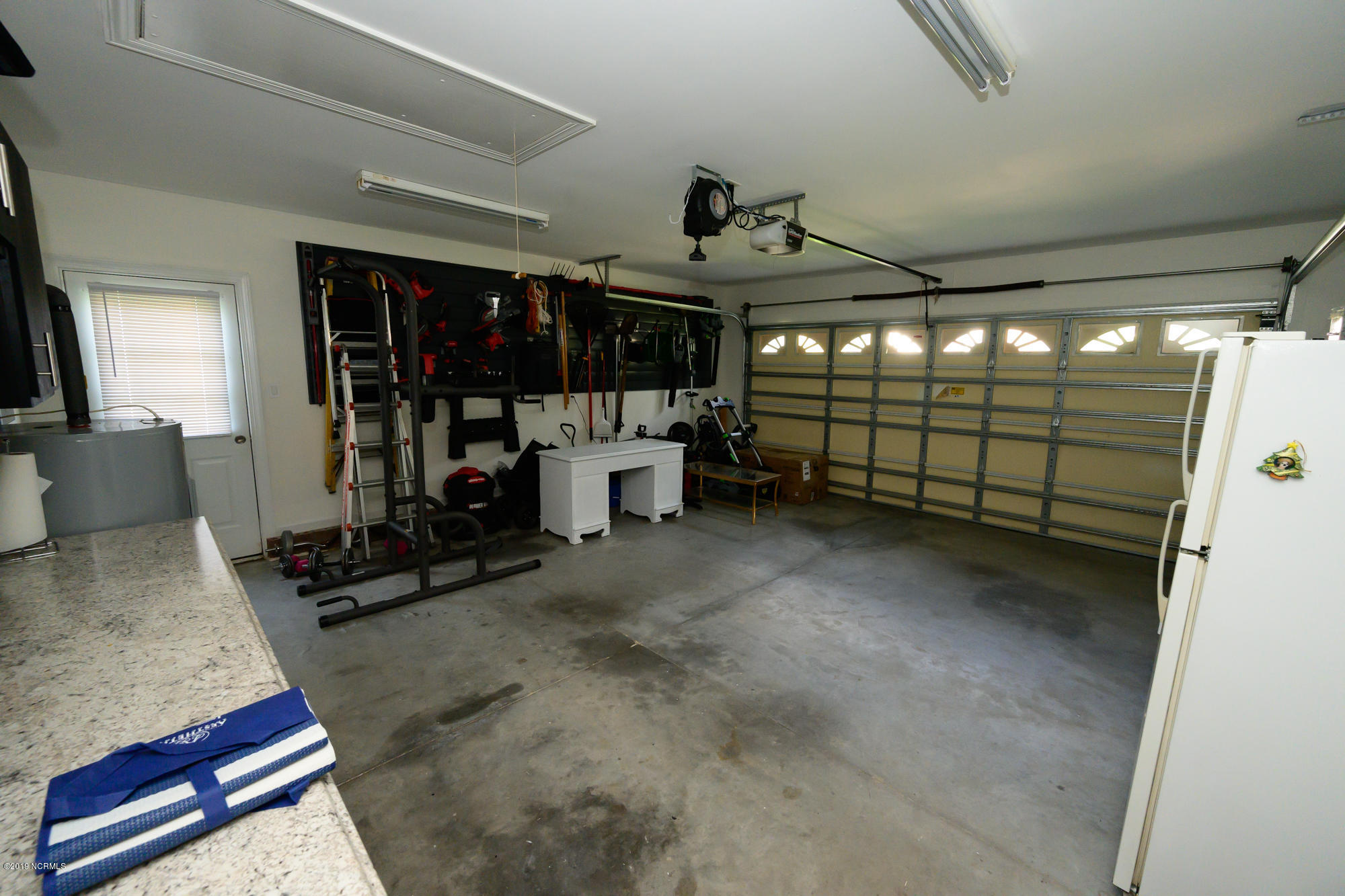 433 Neuchatel Road New Bern, NC 28562 - Photo 27 of 30 garage with nice cabinets and hooks