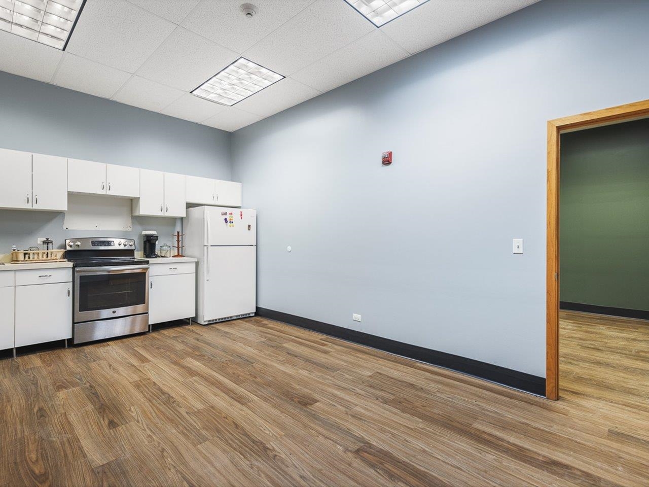 11635 Wange Road Capron, IL 61012 - Photo 24 of 57 a kitchen with a refrigerator and a stove top oven