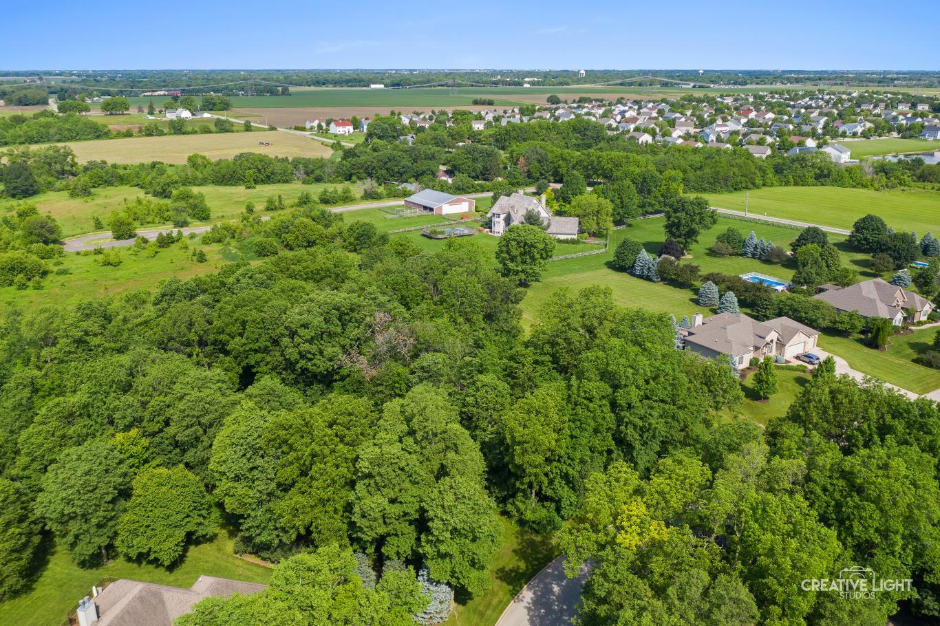 Lot #30 Mitchell Drive Plano, IL 60545 - Photo 4 of 12 a view of a city with lush green forest