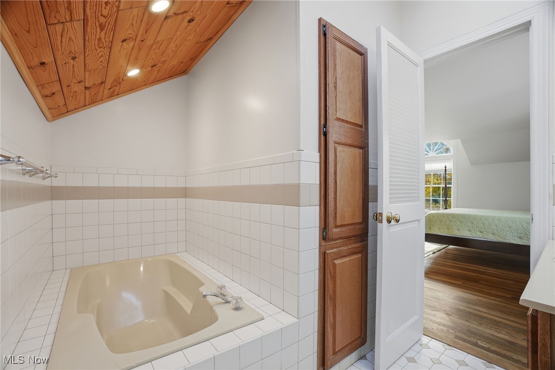 4441 Lake Road West Ashtabula, OH 44004 - Photo 26 of 46 Bathroom featuring lofted ceiling, a bath, recessed lighting, wooden ceiling, and connected bathroom