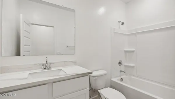 a bathroom with a sink toilet vanity and shower