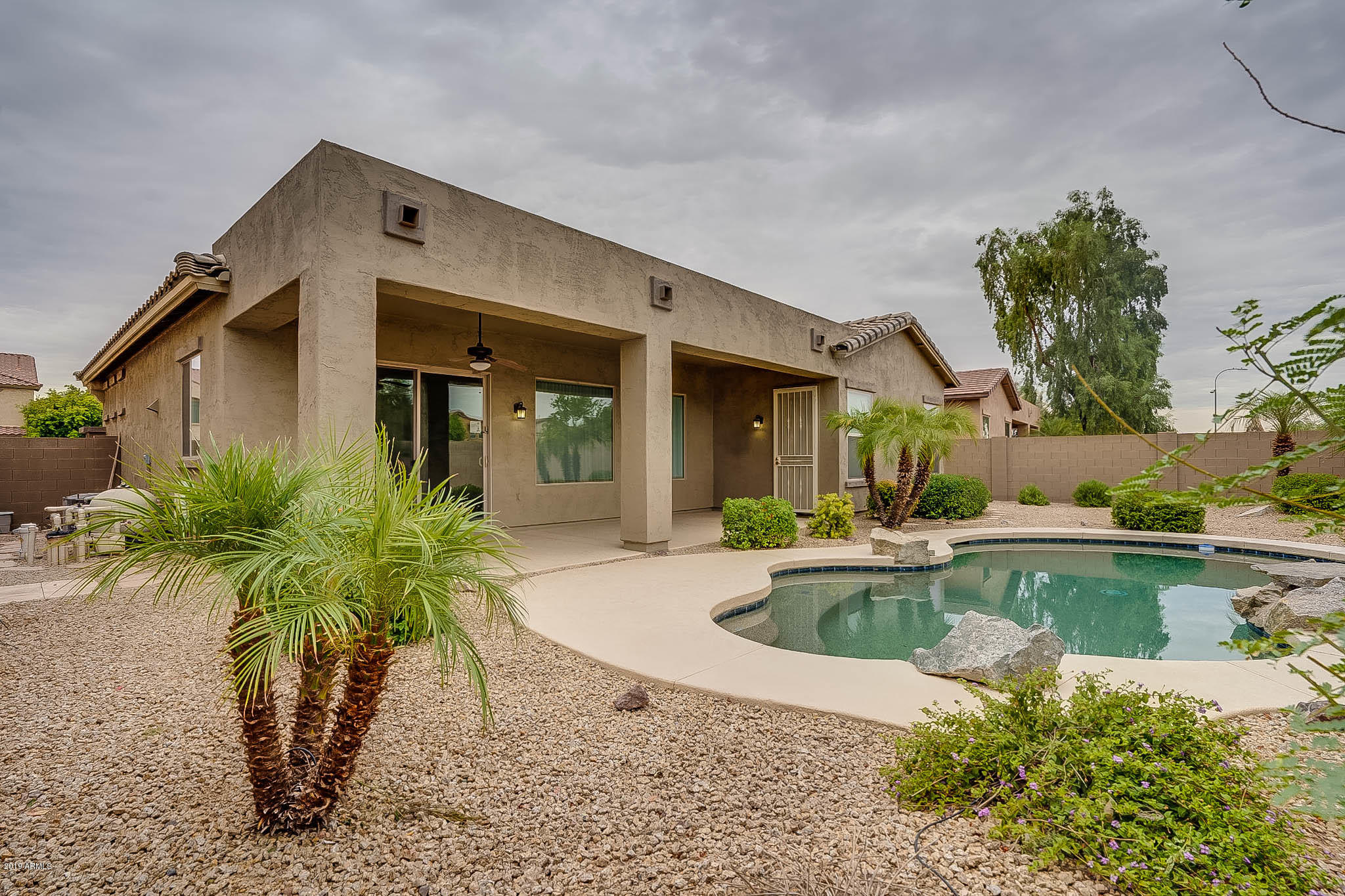 9306 West Rascon Loop Phoenix, AZ 85037 - Photo 2 of 9 a view of a house with pool porch and sitting area