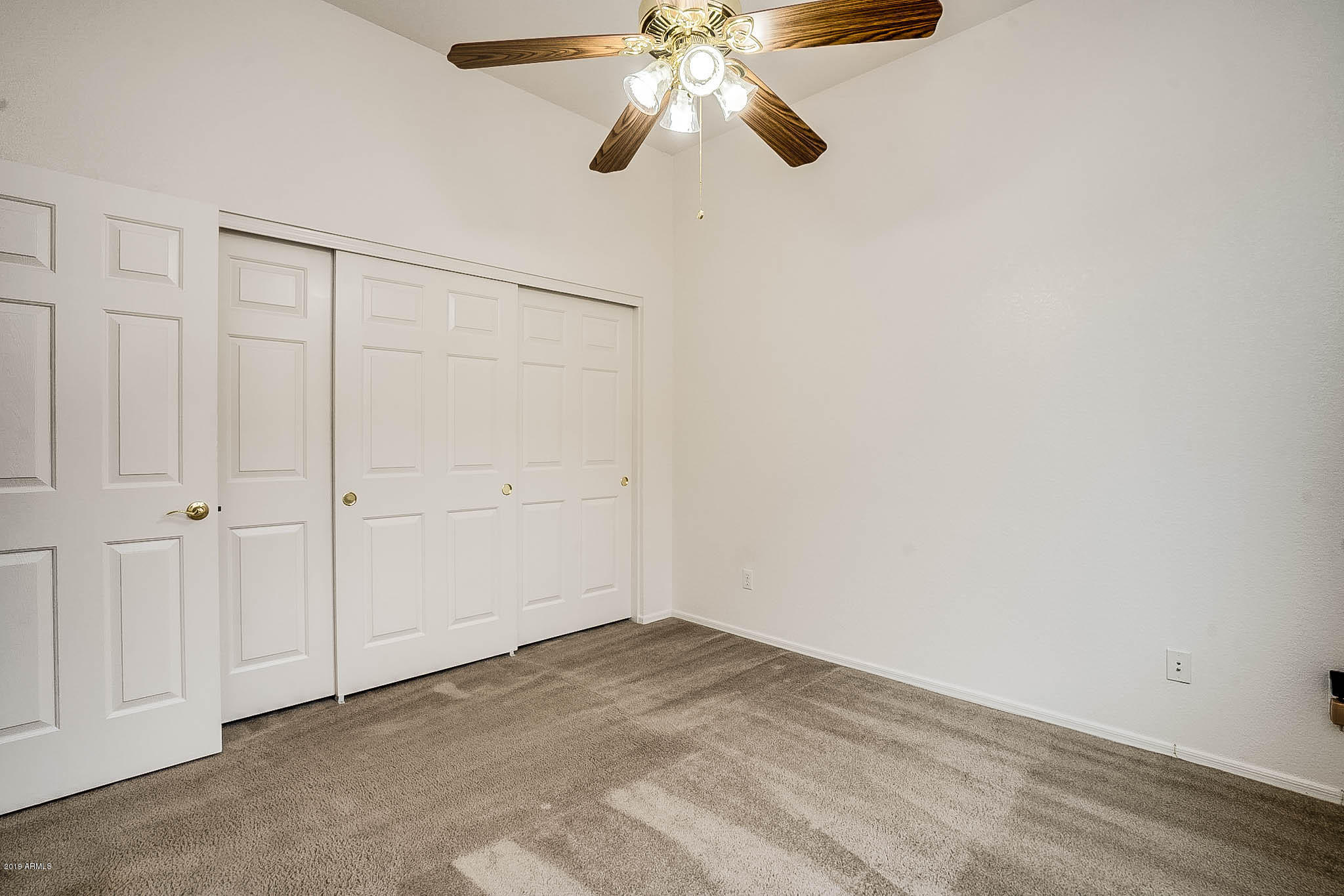9306 West Rascon Loop Phoenix, AZ 85037 - Photo 4 of 9 wooden floor in an empty room